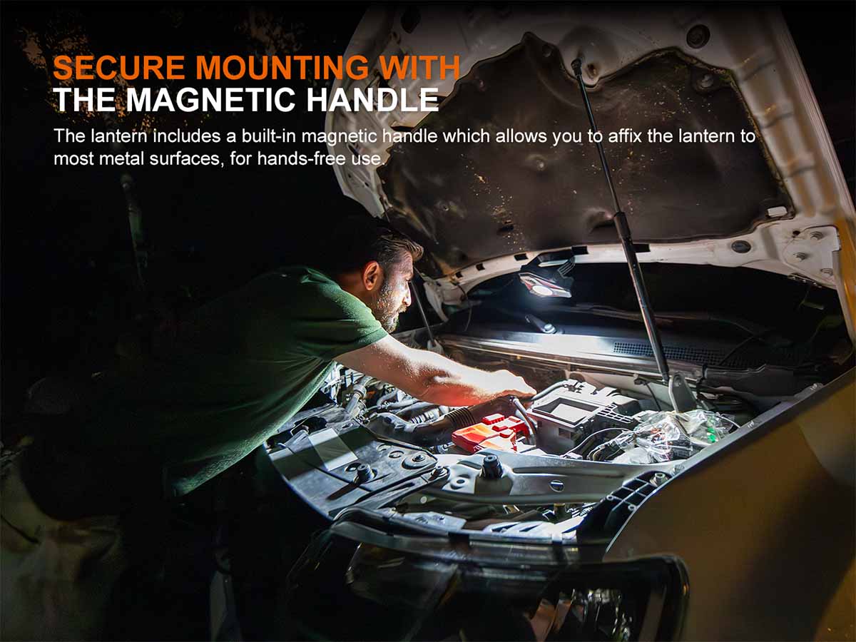 Person working on a vehicle with the Fenix CP50R lantern's magnetic handle attached to the hood