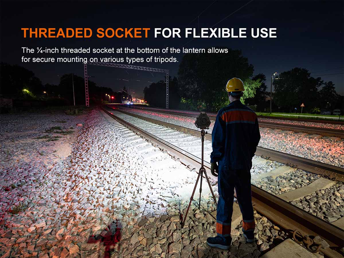 Person with the Fenix CP50R lantern mounted to a tripod and light on train tracks at night, highlighting threaded socket feature.